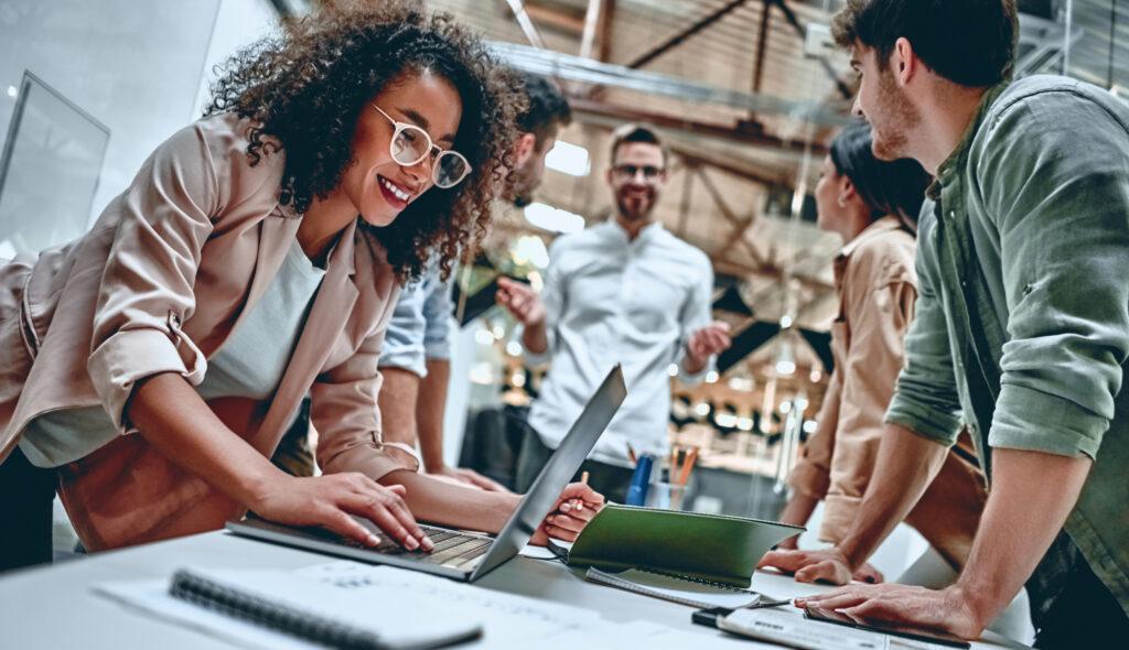 happy business team strategising around a desk